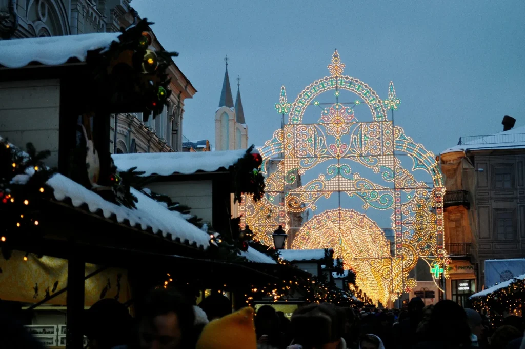 Christkindlesmarkt Nürnberg bei Abenddämmerung – festlich beleuchtete Buden und großer Lichterbogen in der Altstadt