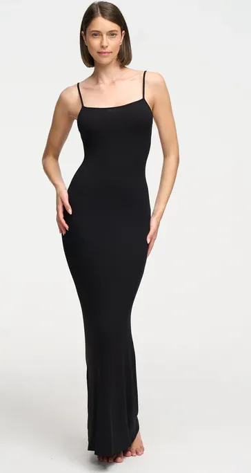 Frau trägt schwarzes, körpernahes Maxikleid von Creamy Fabrics mit schmalen Trägern