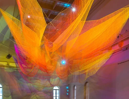 Großformatige String-Art-Installation aus farbigen Fäden im Museumsraum von Janet Echelman
