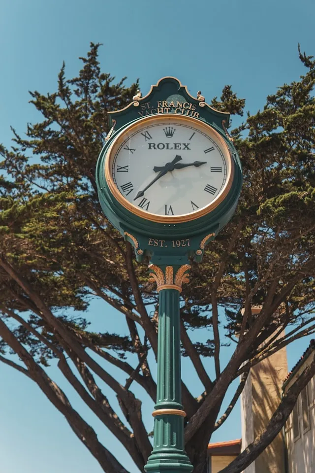 Rolex Uhr am St. Francis Yacht Club in San Francisco vor blauem Himmel und Bäumen