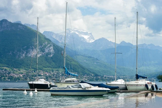 Segelboote auf dem Lac d’Annecy vor der Kulisse der französischen Alpen